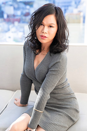 Busty ladyboy Mimi shows her shaved cock and big ass